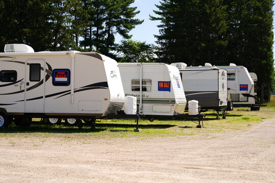 Fuel, Springdale, Guide, and many other brands of 5th Wheel campers sit stored at a storage site.