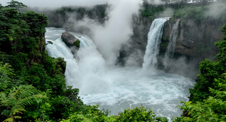 Majestic waterfall surrounded by lush greenery
