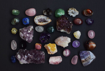 Background of beautiful natural colored semi-precious stones. Purple fluorite, rose quartz and...