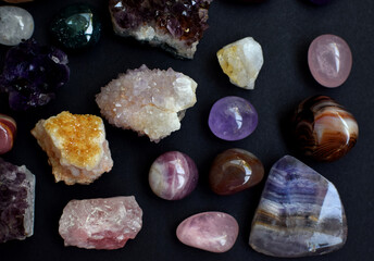 Background of beautiful natural colored semi-precious stones. Purple fluorite, rose quartz and...