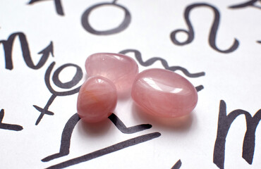 Beautiful rose quartz crystals with zodiac signs symbols. Predictions, witchcraft, spiritual...