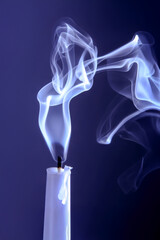 Smoke from an extinguished candle on a dark background. The concept of spirituality and the end of...
