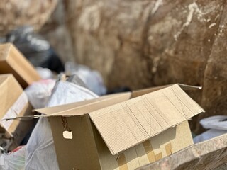 An old rusty dumpster sitting on a bustling city street filled with urban life and debris. The...