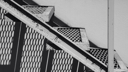 Industrial Metal Staircase with Patterned Shadows