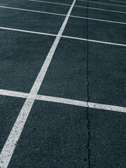 Fototapeta premium Cracked Asphalt Surface With Parking Grid Lines 