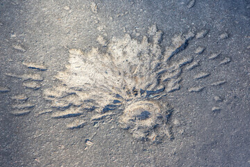 crater from a mine explosion on the bridge square of the city during the war in Ukraine