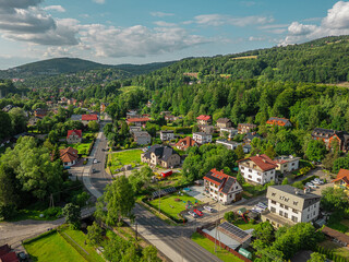 Aerial view of a charming mountain village in the Beskid Mountains, Poland, on a sunny summer day