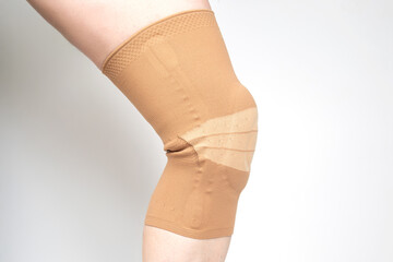 bandage for fixing the injured knee of the human leg on a white background. medicine and sports....