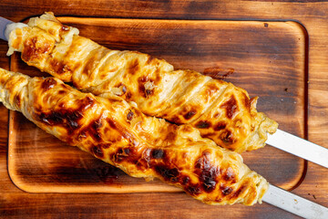 Delicious grilled kebabs served on skewers with a crispy outer layer and juicy filling