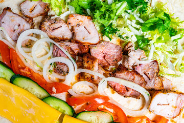 Tasty grilled chicken wrap with fresh vegetables and toppings ready for a delicious meal