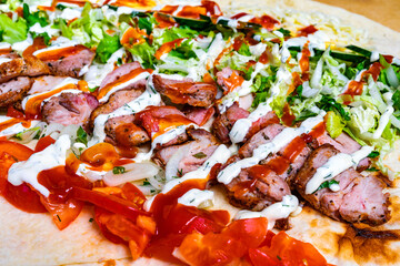 Delicious wrap filled with grilled meat and fresh vegetables served at a local eatery during the afternoon