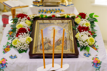 Spiritual altar adorned with flowers and candles in a serene religious setting