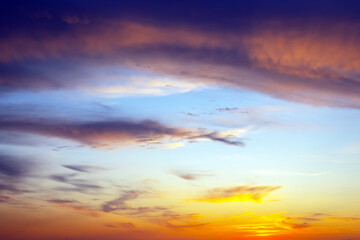 Dramatic evening sky filled with heavy storm clouds and patches of golden light. The interplay of...
