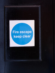Fire exit keep clear sign on construction building site door