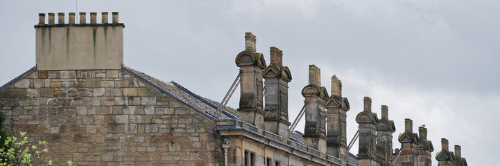 Chimney pots in a row on old victorian building roof
