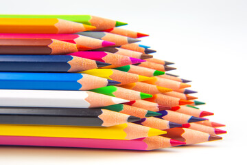 Brightly colored pencils in a wavy row against a white surface. Perfect for promoting art...