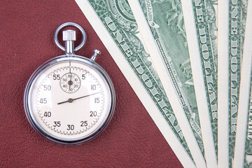 mechanical stopwatch on the background of dollars. Part time accuracy for business. business and...