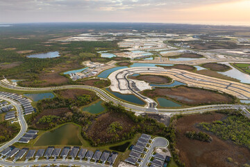 Development of real estate market in the USA. Aerial view of large construction site with building...