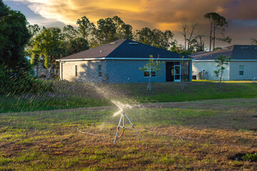 Irrigation automatic sprinkler for lawn watering. Keeping grass green during dry season