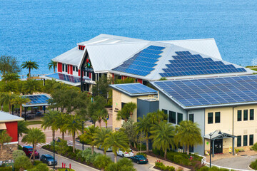 Solar photovoltaic panels installed on top of Florida office buildings for producing clean...