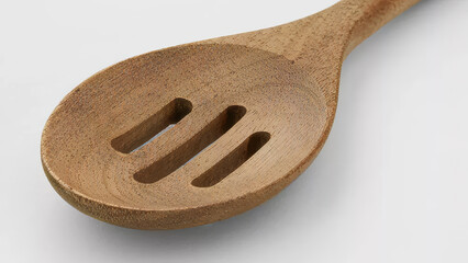 Wooden cooking spoon with slits ideal for stirring and serving food at home or in professional...