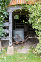 old bran tub for feeding horses on an iron trolley.