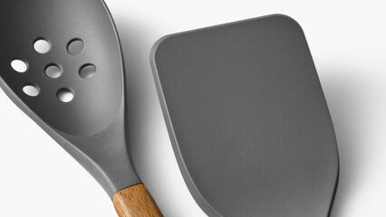 Cooking utensils positioned on a clean surface ready for food preparation in a modern kitchen...