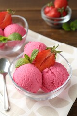 Tasty sorbet with strawberries and mint served on wooden table, closeup
