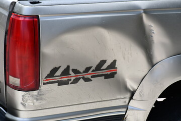 4x4 emblem on damaged rear quarter panel of pickup truck. Late 90's to early 2000's