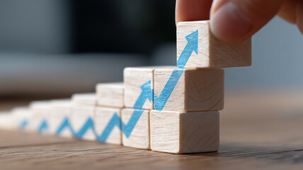 Strategic growth visualization built with stacking arrow blocks representing progressive business development.
