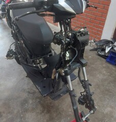 Obraz premium Disassembled motorbike frame and rim spraying in workshop