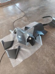 Disassembled motorbike frame and rim spraying in workshop