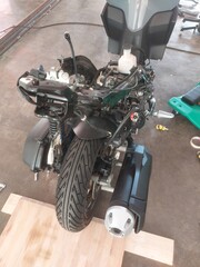 Disassembled motorbike frame and rim spraying in workshop