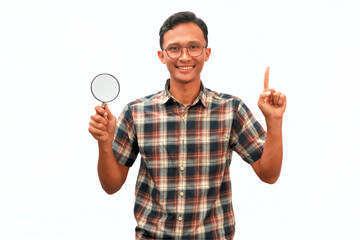 An Asian man holding a magnifying glass with a happy expression