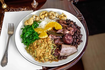 The best traditional Brazilian feijoada completely served in the most authentic style accompanied by the irresistible and iconic cachaça caipirinha
