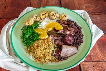 The best traditional Brazilian feijoada completely served in the most authentic style accompanied by the irresistible and iconic cachaça caipirinha