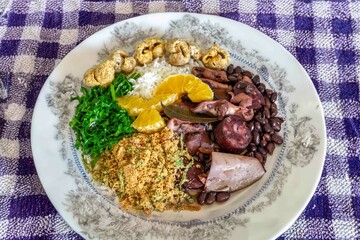 The best traditional Brazilian feijoada completely served in the most authentic style accompanied by the irresistible and iconic cachaça caipirinha