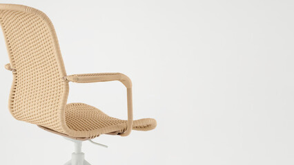 Unique wicker office chair design in a minimalist workspace setting.