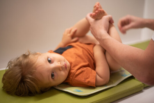 Father changing his 16-month-old son's diaper