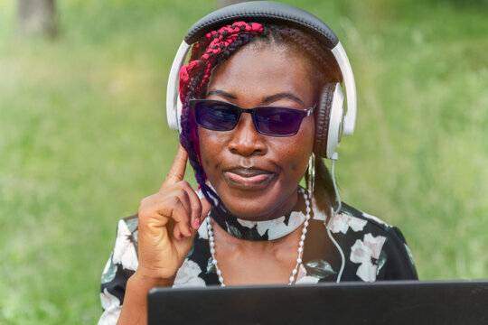 Young African American Woman with Headphones Listening Music