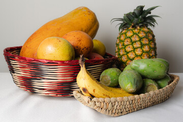 Fresh tropical fruits arranged in wicker baskets displaying vibrant colors and textures