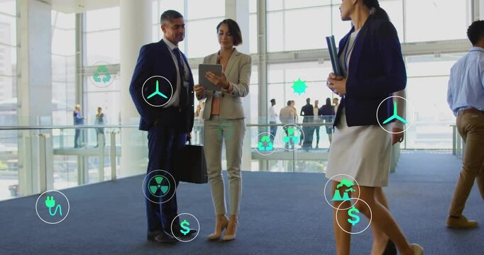Corporate team consulting tablet and generating sustainability icons by railing for cost insights