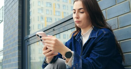 Young woman exploring smartphone near urban window, displaying diverse emotions and casual interactions with digital technology across multiple dynamic shots - Powered by Adobe