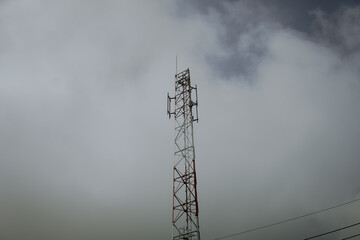Cell Tower Reaching into the Cloudy Sky