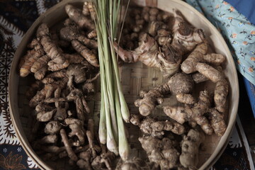 Fresh Turmeric, Ginger, and Lemongrass on a Wooden Tray