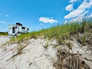 Truck camper tucked in dunes.  Enjoying the tranquil permit only beach at Sore Thumb 4x4 access...