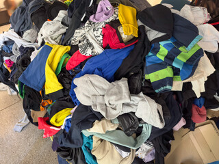 Abandoned Clothes on Collapsed Table – Secondhand or Donation Center Scene
