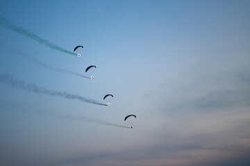 Powered Paragliders Perform Smoke Trail Formation at Dusk