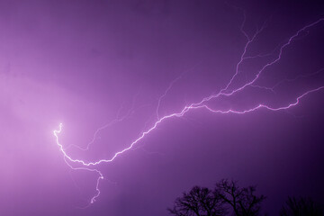 Purple Night Sky Illuminated by Forked Lightning
