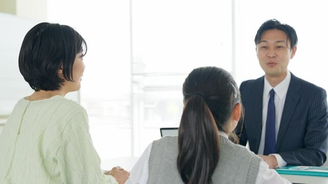 Parent and child having a three-way interview